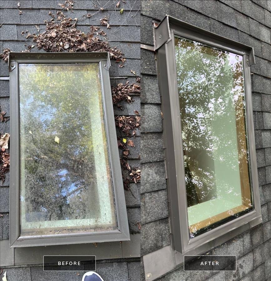 Before and after comparison of a skylight on an asphalt shingle roof, the before pane clouded with grime and surrounded by leaf debris and the after pane fully clear and reflecting trees