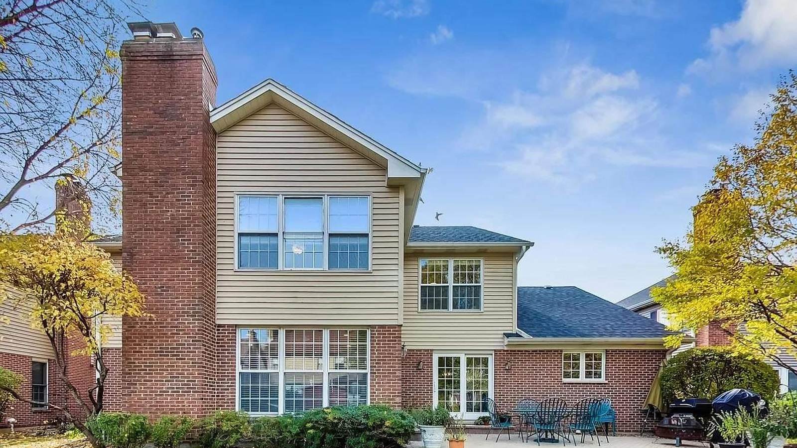 Brick and siding two-story home in Arlington Heights, IL after exterior window and gutter cleaning