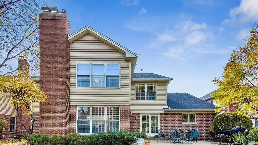 Brick and siding two-story home in Arlington Heights, IL after exterior window and gutter cleaning