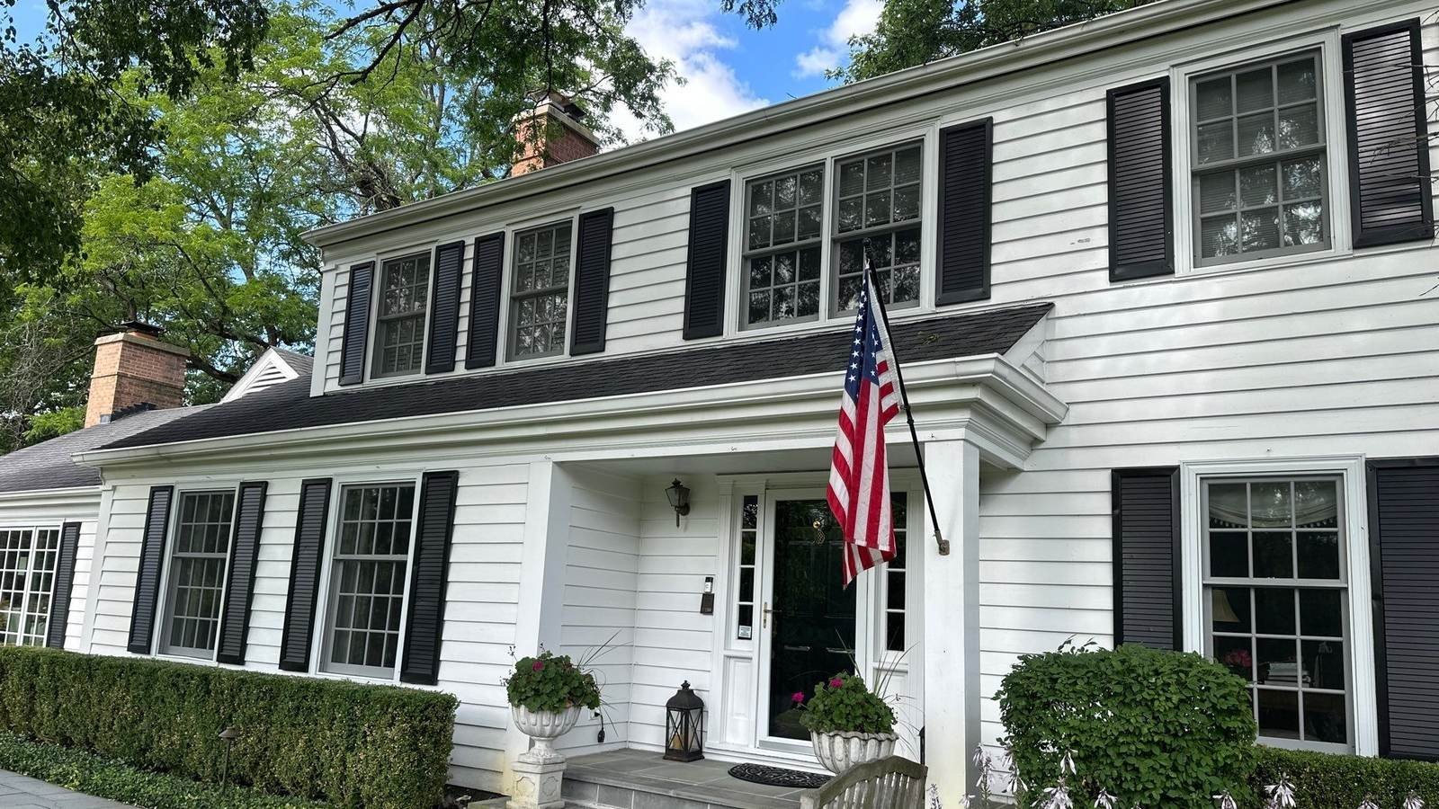 White colonial home with divided light windows cleaned by Pane Pal