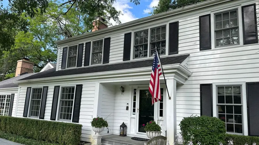 White colonial home with divided light windows cleaned by Pane Pal